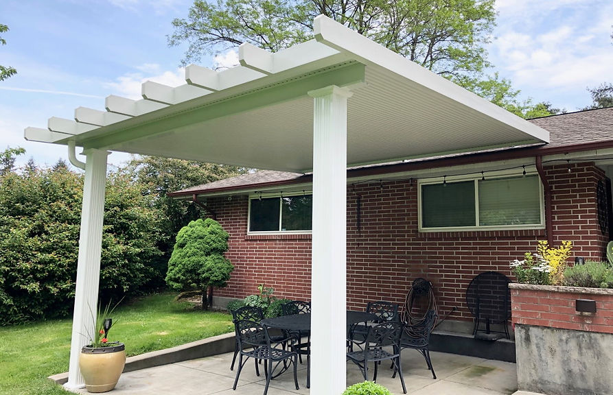 Flat-pan aluminum patio cover attached to a residential home